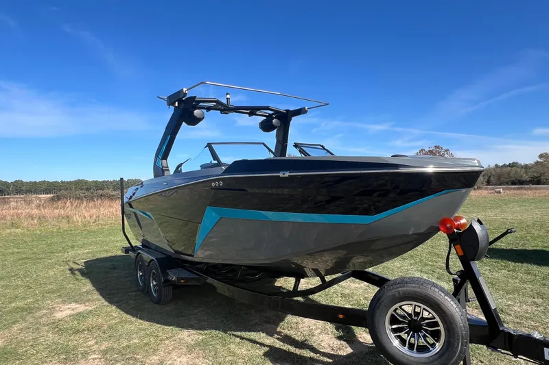 The Image of 2026 Tigé Z3 boat on trailer, parked on grassy field under clear blue sky. - 0