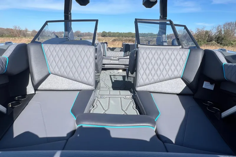 Slide: The Image of 2026 Tigé Z3 boat interior with gray diamond-stitched seats and teal accents. - 19