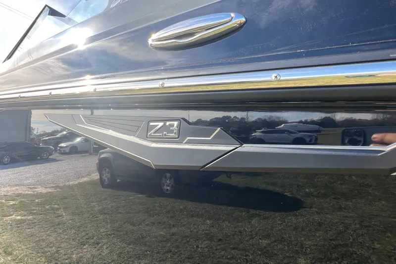 Slide: The Image of 2026 Tigé Z3 boat side view with sleek design and chrome detailing. - 2