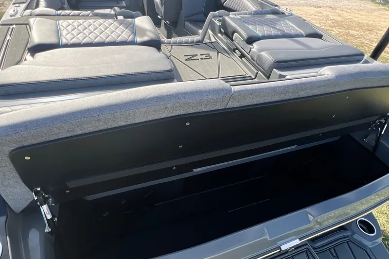 Slide: The Image of 2026 Tigé Z3 boat interior with open storage compartment and cushioned seating. - 6