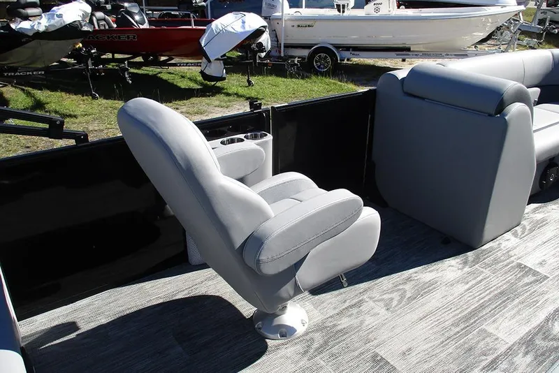 Slide: The Image of 2026 Bentley Pontoons Legacy 223 Swingback interior with gray seating and cup holders. - 17