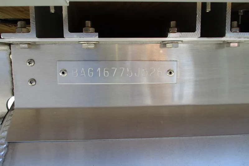 Slide: The Image of 2026 Bentley Pontoons Legacy 223 Swingback serial number plate on metal surface. - 28