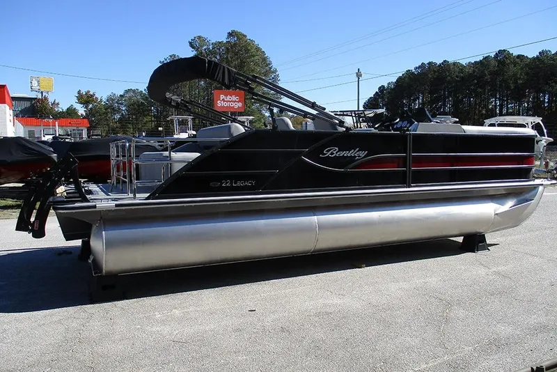 Slide: The Image of 2026 Bentley Pontoons Legacy 223 Swingback pontoon boat in a parking lot. - 6