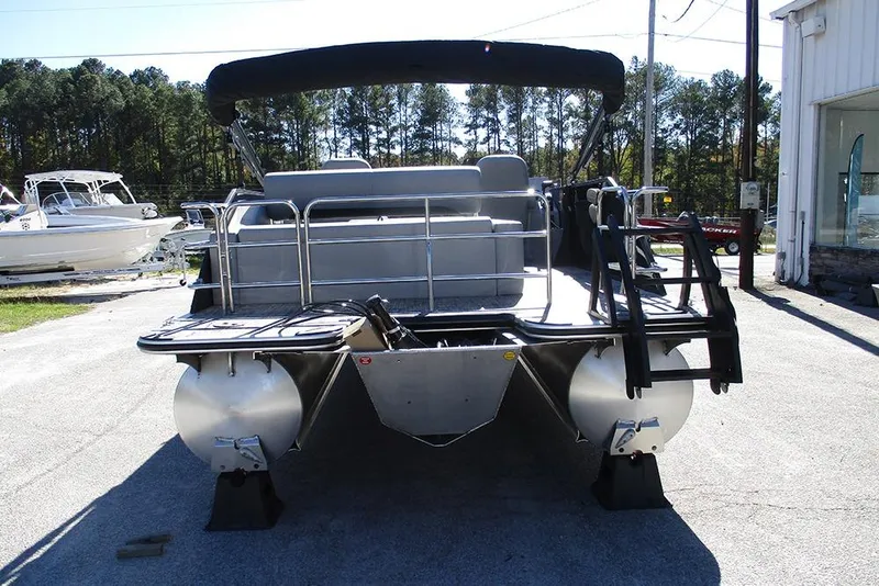 Slide: The Image of 2026 Bentley Pontoons Legacy 223 Swingback, rear view, parked outdoors. - 7