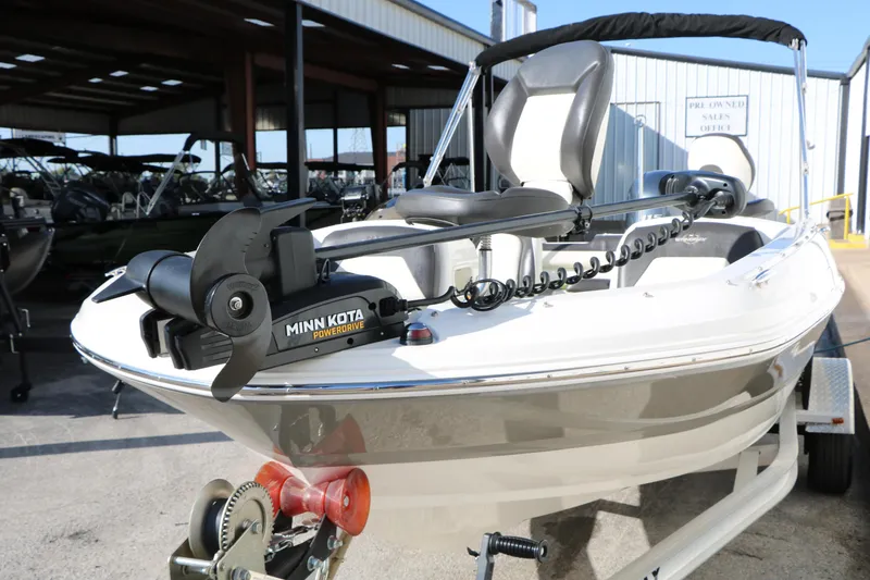 Slide: The Image of 2018 Stingray 182 SC boat with Minn Kota PowerDrive motor in a sales lot. - 11