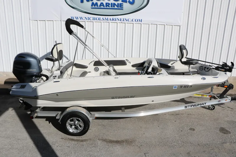 Slide: The Image of 2018 Stingray 182 SC boat on trailer, displayed at Nichols Marine. - 14