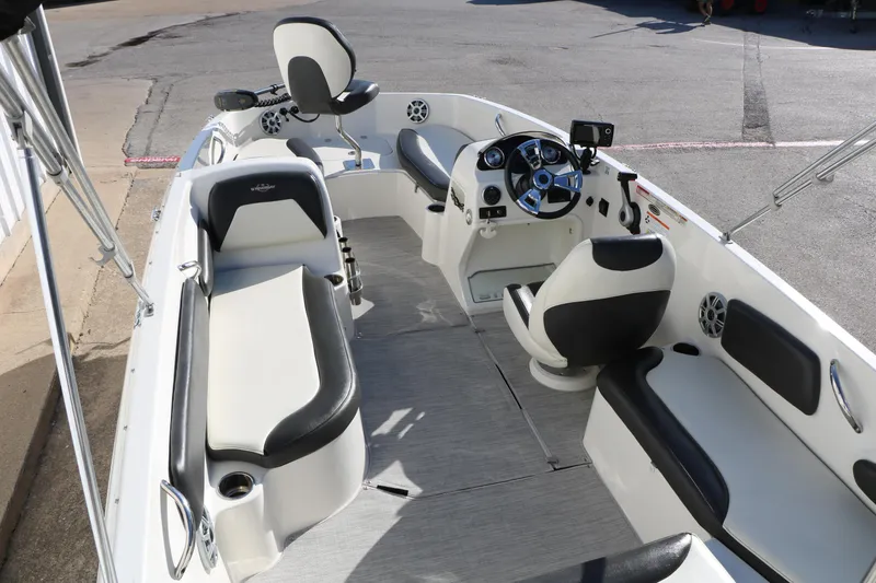 Slide: The Image of 2018 Stingray 182 SC boat interior with seating, steering console, and modern design. - 15