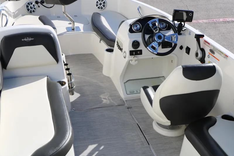 Slide: The Image of 2018 Stingray 182 SC boat interior with steering wheel and seating. - 16