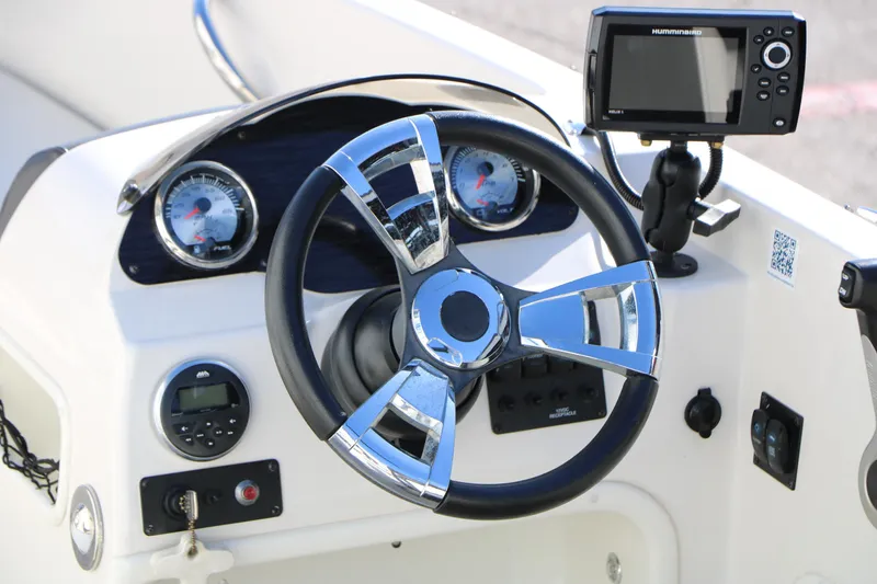 Slide: The Image of 2018 Stingray 182 SC boat dashboard with steering wheel and navigation system. - 17
