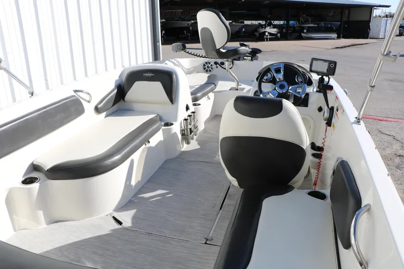Slide: The Image of 2018 Stingray 182 SC boat interior with seating, steering wheel, and control panel. - 19