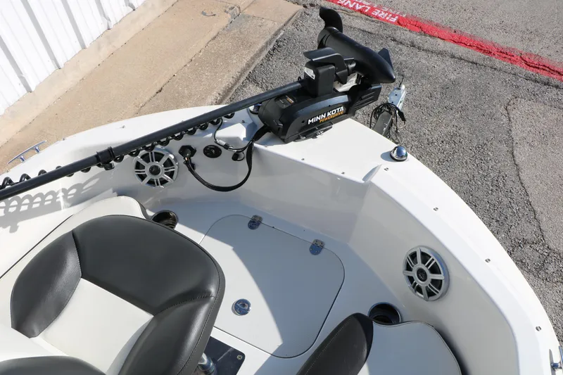 Slide: The Image of 2018 Stingray 182 SC boat interior with Minn Kota trolling motor and seating. - 21