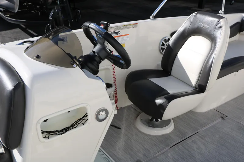 Slide: The Image of 2018 Stingray 182 SC boat interior with steering wheel and seating. - 25