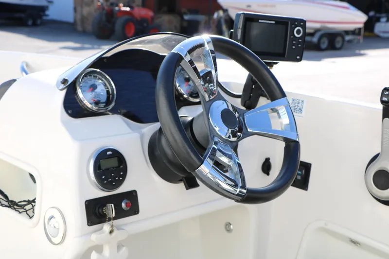 Slide: The Image of 2018 Stingray 182 SC boat dashboard with steering wheel and navigation system. - 30