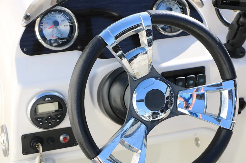Slide: The Image of Steering wheel and dashboard of 2018 Stingray 182 SC boat. - 34