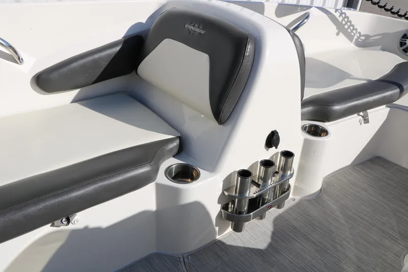 Slide: The Image of 2018 Stingray 182 SC boat interior with cushioned seating and cup holders. - 35