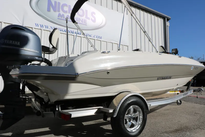 Slide: The Image of 2018 Stingray 182 SC boat on trailer, Yamaha engine, parked at Nichols Marine. - 4