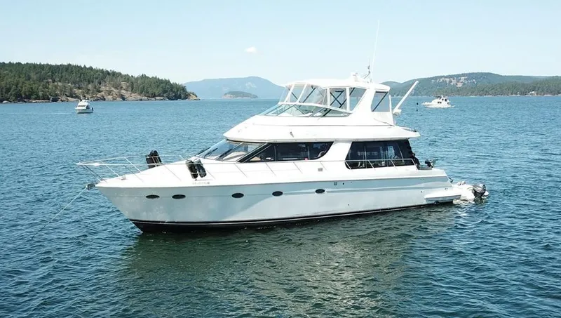 Slide: The Image of 2000 Carver 530 Voyager Pilothouse yacht on serene blue waters. - 1
