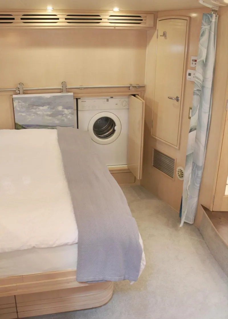 Slide: The Image of 2000 Carver 530 Voyager Pilothouse interior with bed and built-in washing machine. - 13