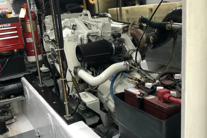 Slide: The Image of Engine room of a 2000 Carver 530 Voyager Pilothouse with visible components and fire extinguisher. - 16