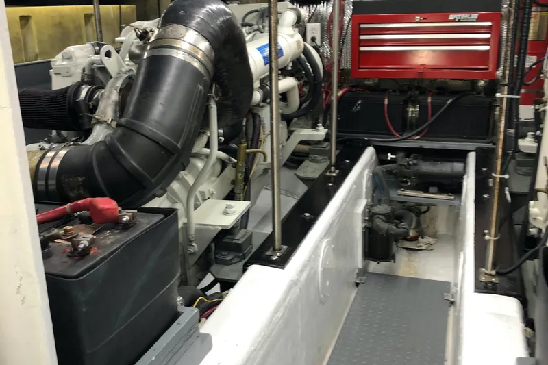 Slide: The Image of Engine room of 2000 Carver 530 Voyager Pilothouse with visible machinery and tool storage. - 17