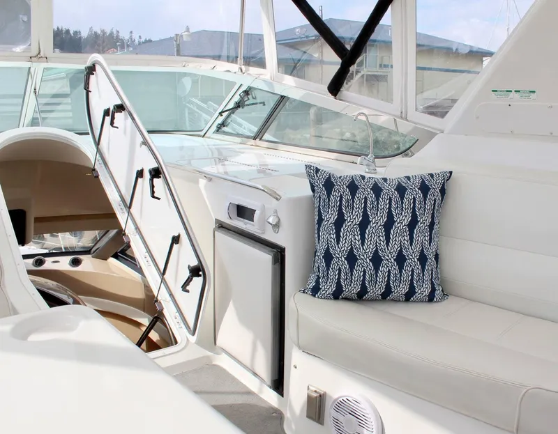 Slide: The Image of Interior of 2000 Carver 530 Voyager Pilothouse with seating and nautical-themed pillow. - 18