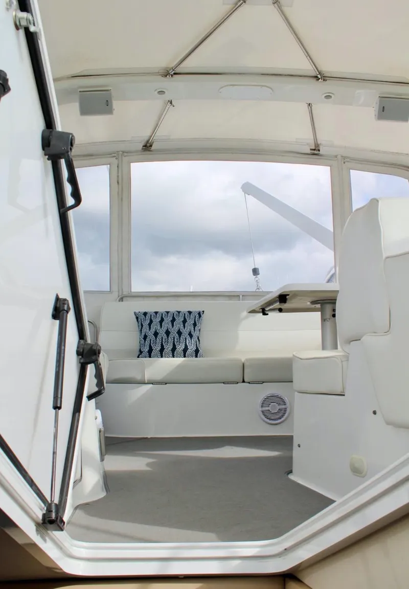 Slide: The Image of Interior view of 2000 Carver 530 Voyager Pilothouse with white seating and nautical decor. - 21