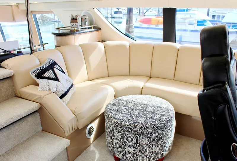 Slide: The Image of Luxurious interior of 2000 Carver 530 Voyager Pilothouse with beige seating and patterned ottoman. - 5