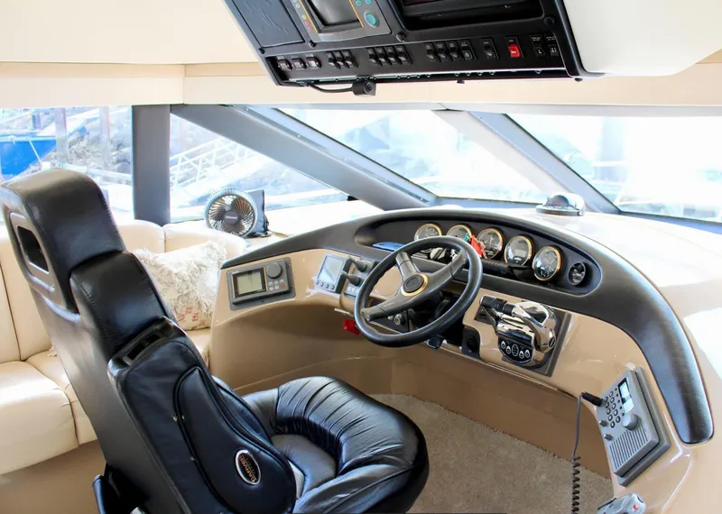 Slide: The Image of Pilothouse interior of 2000 Carver 530 Voyager, featuring steering wheel and control panel. - 6