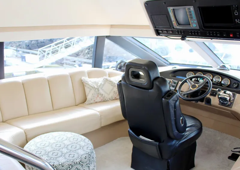 Slide: The Image of Luxurious interior of 2000 Carver 530 Voyager Pilothouse with leather seating and modern helm. - 7