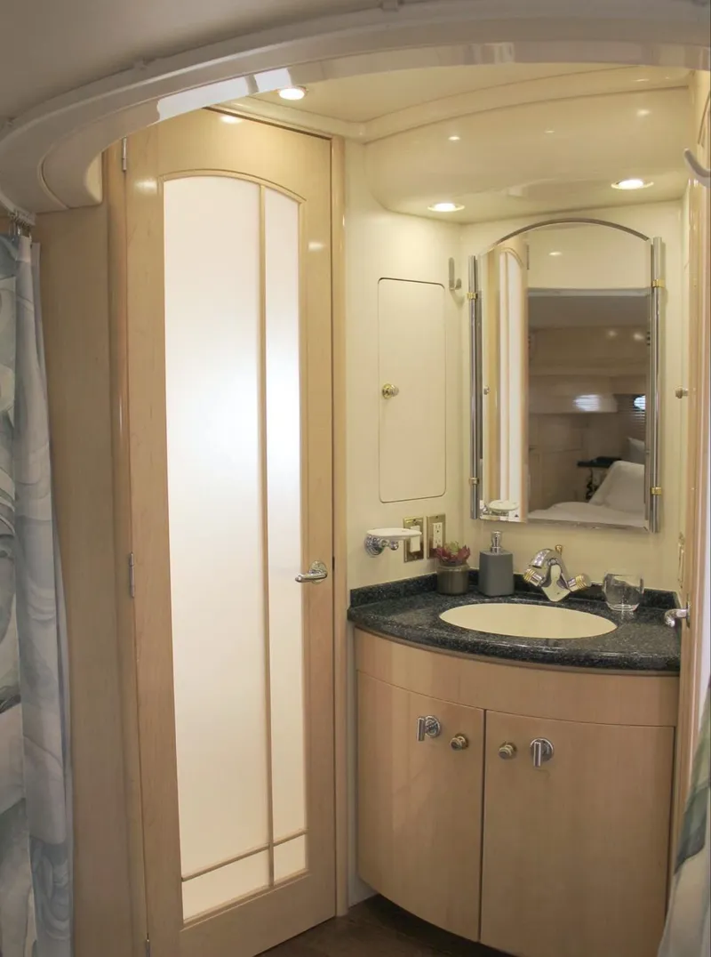 Slide: The Image of 2000 Carver 530 Voyager Pilothouse bathroom with modern fixtures and wood cabinetry. - 9