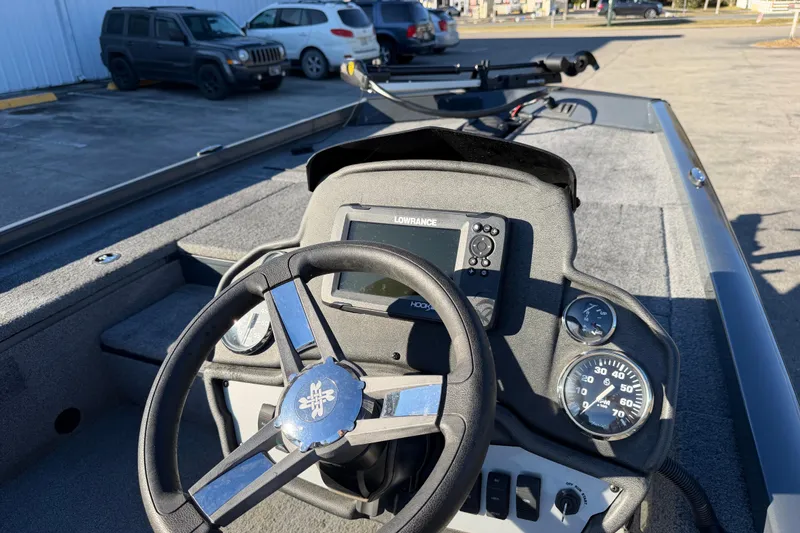 Slide: The Image of 2022 Ranger RT178 boat dashboard with steering wheel and Lowrance display. - 11