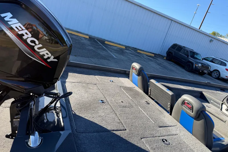 Slide: The Image of 2022 Ranger RT178 boat with Mercury engine, featuring blue and black seating. - 13