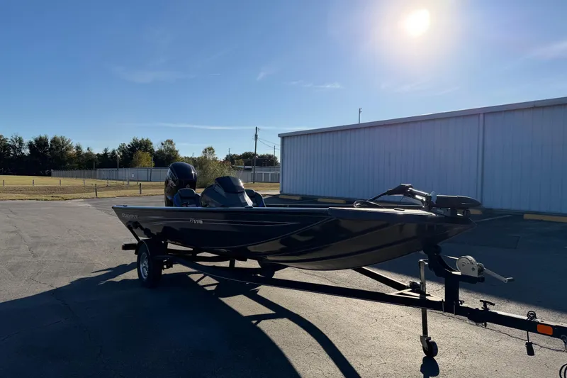 Slide: The Image of 2022 Ranger RT178 boat on trailer under bright sun in parking lot. - 2