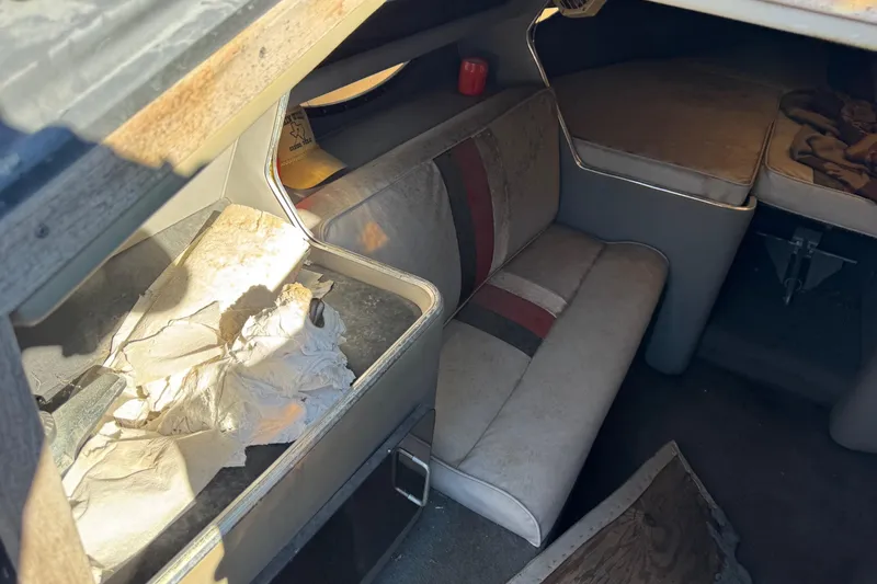 Slide: The Image of 1987 Chaparral Villain IV cabin interior with vintage seating and storage area. - 10