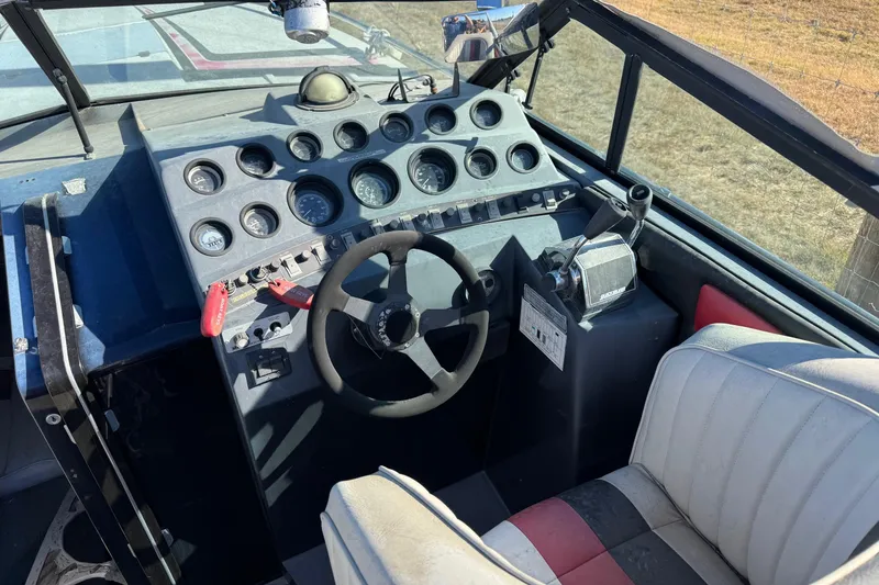 Slide: The Image of 1987 Chaparral Villain IV boat cockpit with steering wheel and instrument panel. - 13