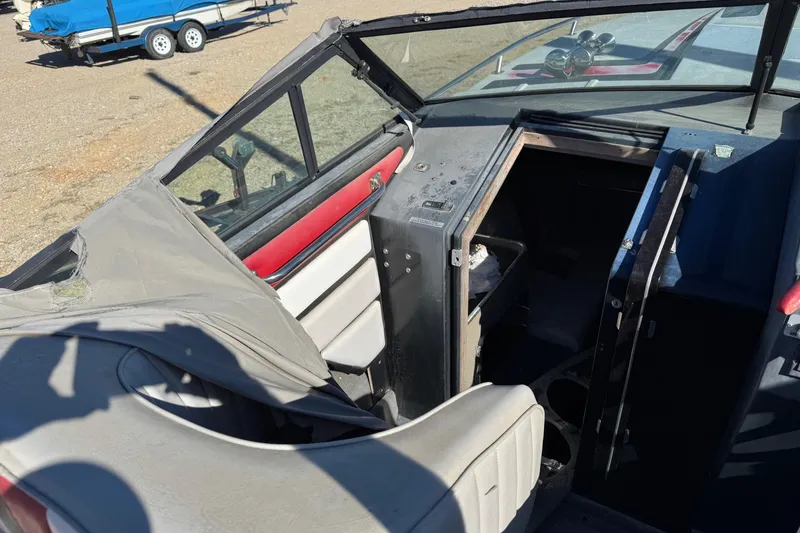 Slide: The Image of 1987 Chaparral Villain IV boat interior with worn upholstery and open cabin door. - 14