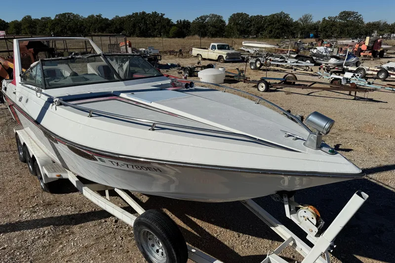 Slide: The Image of 1987 Chaparral Villain IV boat on trailer in outdoor lot. - 3
