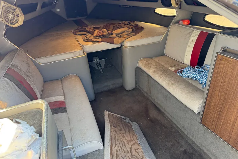 Slide: The Image of Interior of a 1987 Chaparral Villain IV boat with seating and storage. - 5