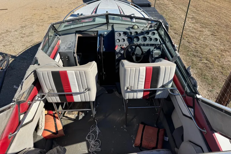 Slide: The Image of 1987 Chaparral Villain IV boat interior with dual seats, steering wheel, and control panel. - 6