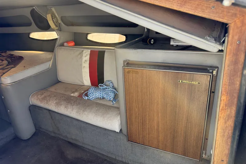 Slide: The Image of Interior of 1987 Chaparral Villain IV boat with seating and Norcold fridge. - 9