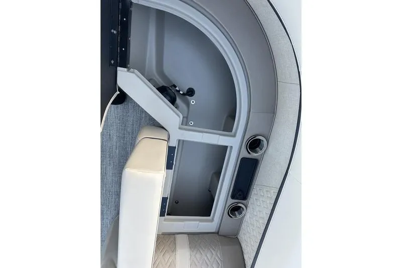 Slide: The Image of Interior view of 2026 Bennington M Quad Bench 22 MFB with storage compartment and cup holders. - 12