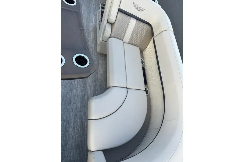 Slide: The Image of Luxurious seating on 2026 Bennington M Quad Bench 22 MFB boat, featuring elegant design and cup holders. - 13