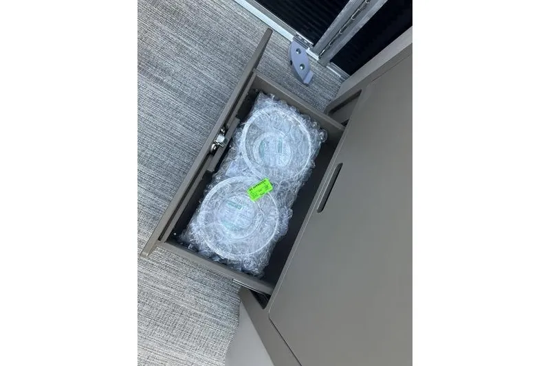 Slide: The Image of Open drawer with bubble-wrapped items in a Bennington M Quad Bench 22 MFB, 2026 model. - 15