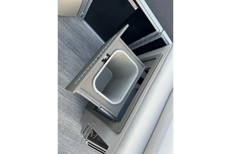 Slide: The Image of Open storage compartment in 2026 Bennington M Quad Bench 22 MFB boat. - 16