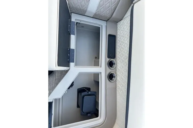 Slide: The Image of 2026 Bennington M Quad Bench 22 MFB interior storage compartment with cup holders. - 22