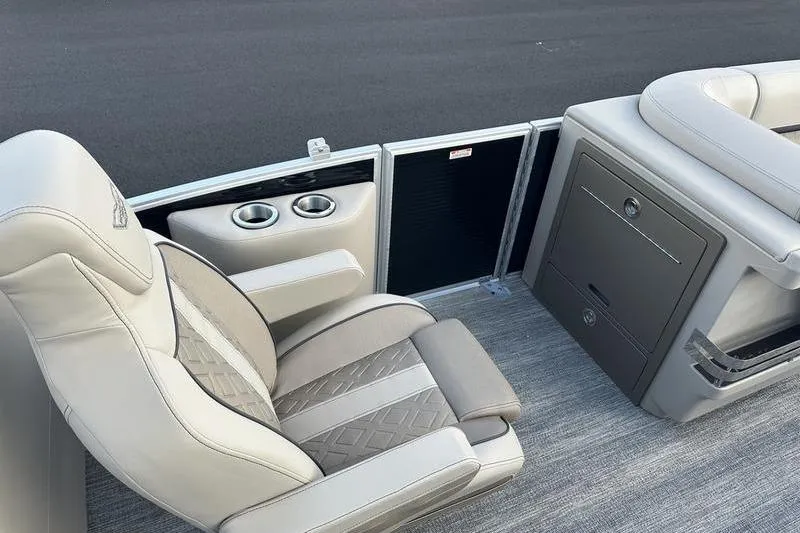 Slide: The Image of Luxurious seating on 2026 Bennington M Quad Bench 22 MFB pontoon boat, featuring cup holders and storage. - 30