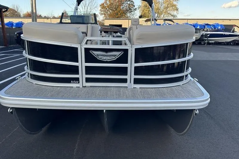 Slide: The Image of 2026 Bennington M Quad Bench 22 MFB pontoon boat, front view, parked on asphalt. - 6