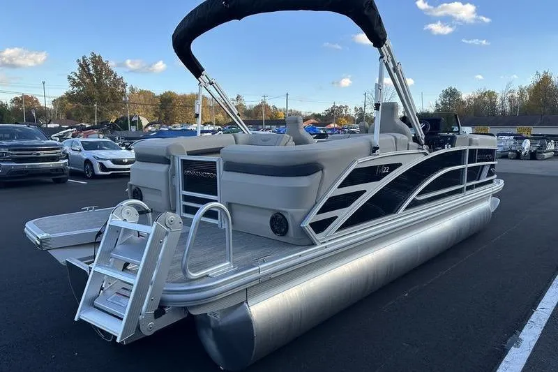 Slide: The Image of 2026 Bennington M Quad Bench 22 MFB pontoon boat in parking lot, sunny day. - 7