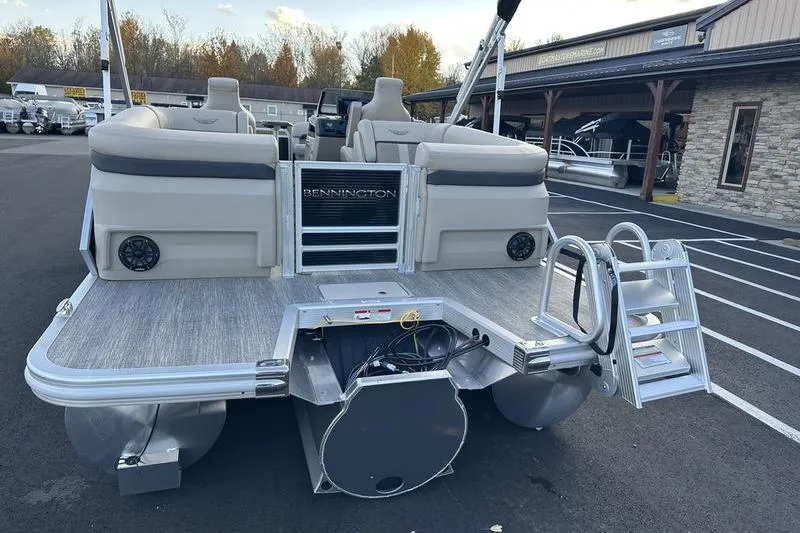 Slide: The Image of 2026 Bennington M Quad Bench 22 MFB pontoon boat, rear view with seating and ladder. - 8