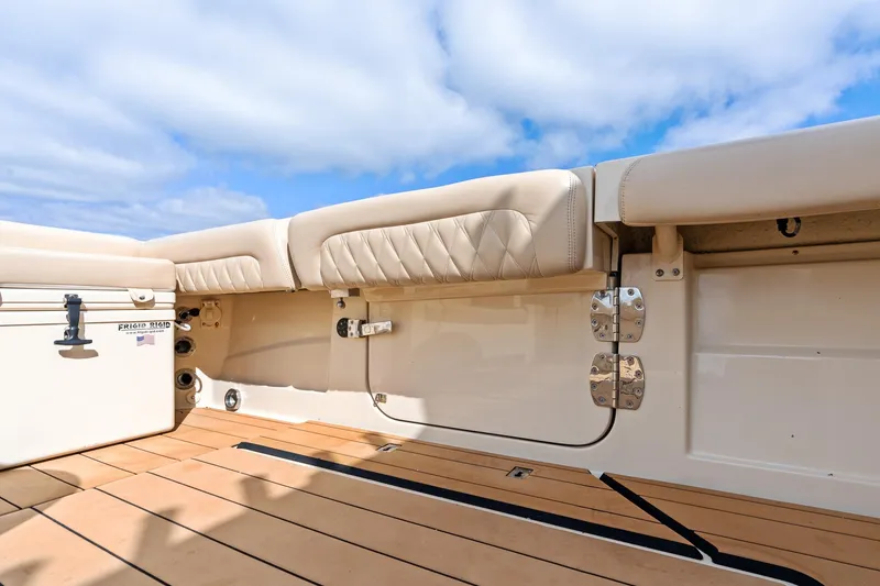 Slide: The Image of 2023 HCB 53 Suenos RXV boat interior with cushioned seating and wooden deck. - 16